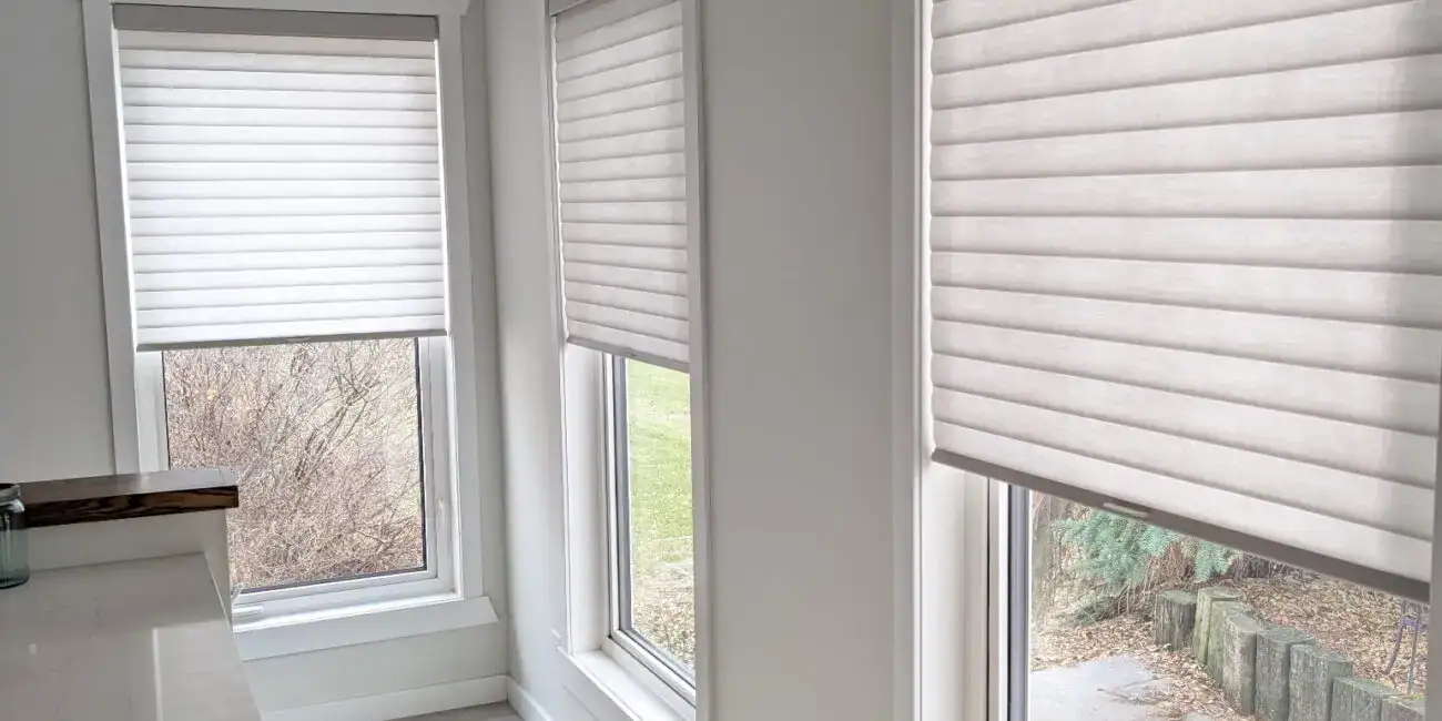 Elegant Sonnette® roller shades providing light control and privacy for large windows. Perfect for enhancing home decor with sleek, functional window treatments.