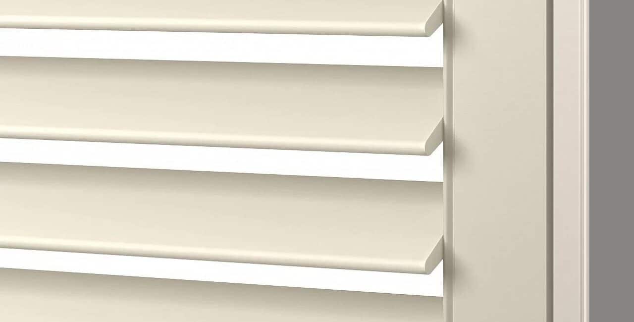 Close-up of beige window blinds with horizontal slats and sturdy frame, ideal for light control and privacy in homes or offices.