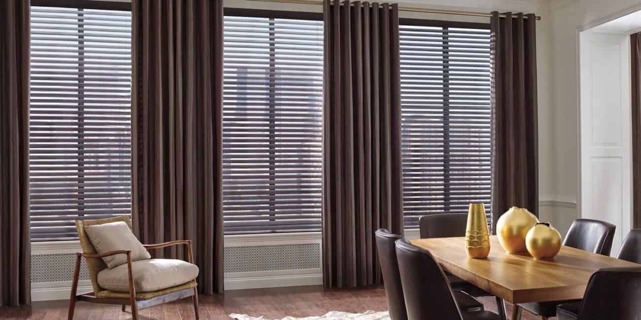Bright dining area featuring wooden blinds, contemporary furniture, and stylish decor accessories.