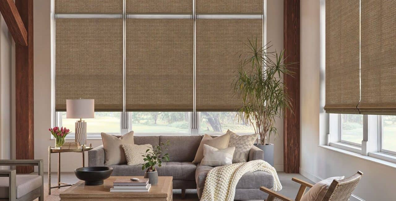 Woven wood shades in a modern living room with natural light, neutral tones, and cozy decor. Perfect for adding warmth and style to any space.