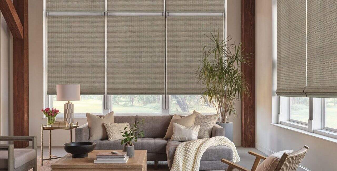 Bright living room with window blinds, comfortable sofa, indoor plants, and modern decor, creating a welcoming and stylish space.