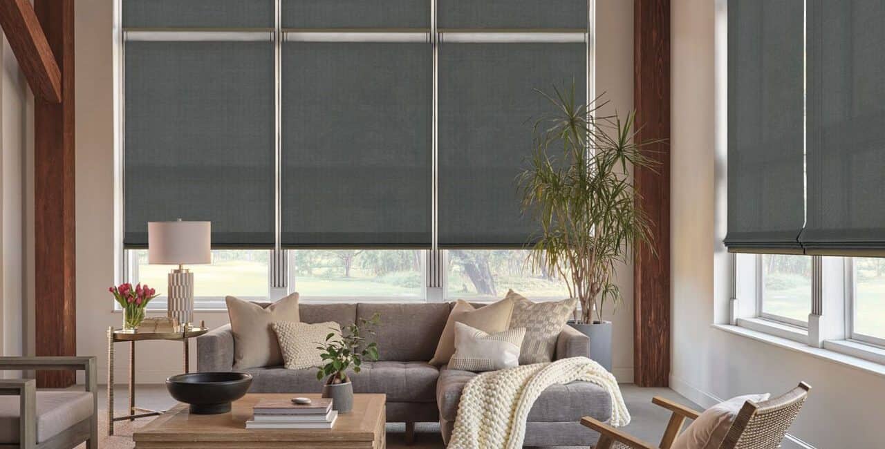 Stylish gray window blinds with natural light, cozy sofa, indoor plants, and minimalist decor create a relaxing atmosphere.
