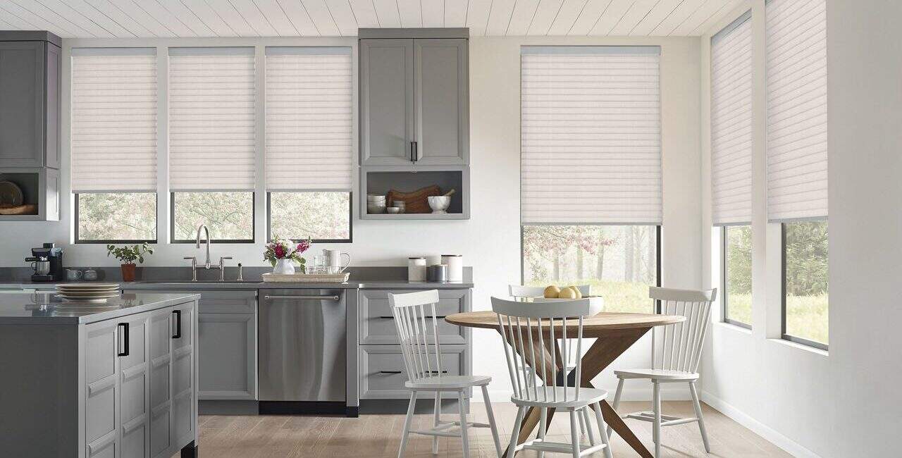 Bright white window blinds in a modern kitchen, allowing natural daylight to illuminate the space and add a fresh, airy ambiance.