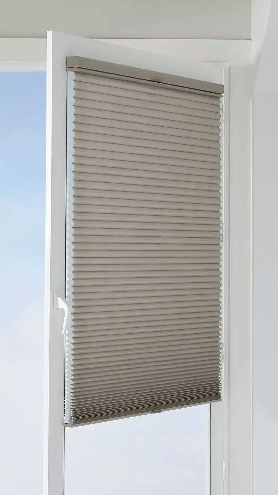 High-quality beige pleated window blind, perfect for enhancing interior décor while providing privacy and adjustable light filtering.