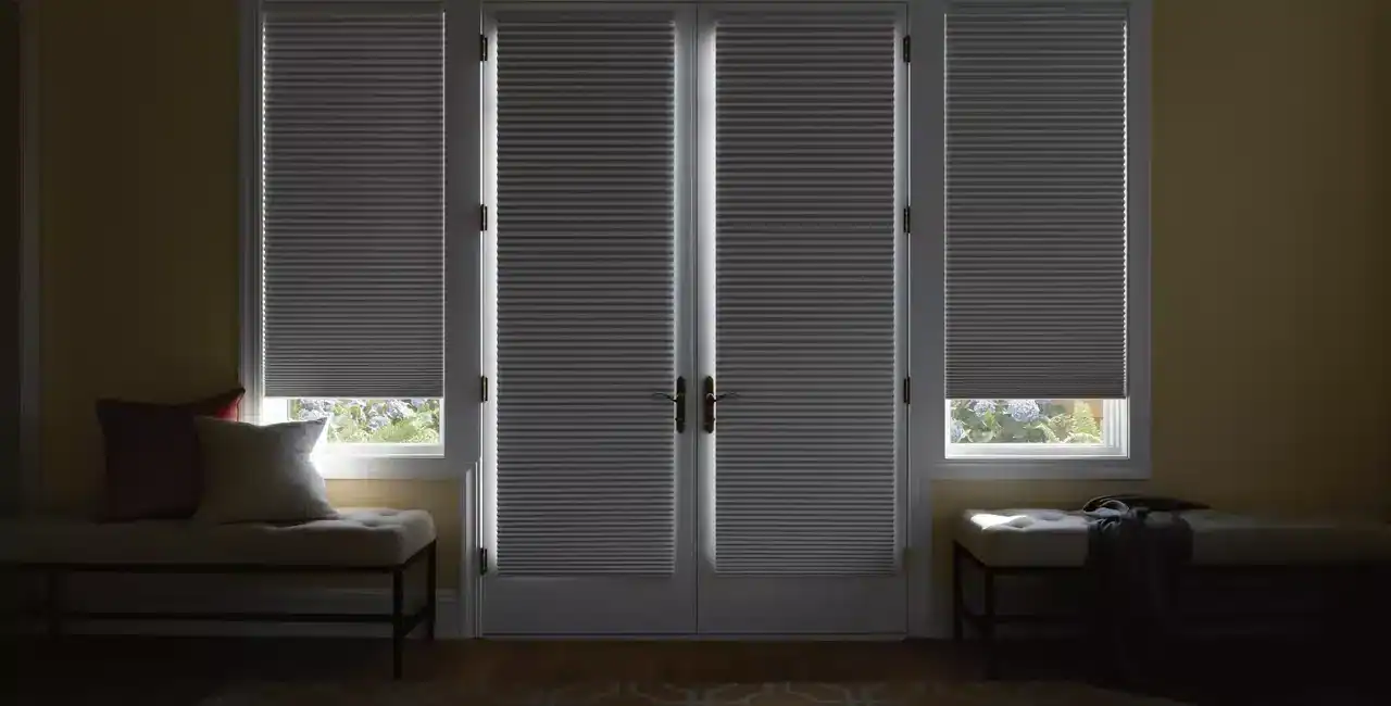 Bright indoor window with blinds, cozy seating, and natural light, creating a warm and inviting atmosphere.