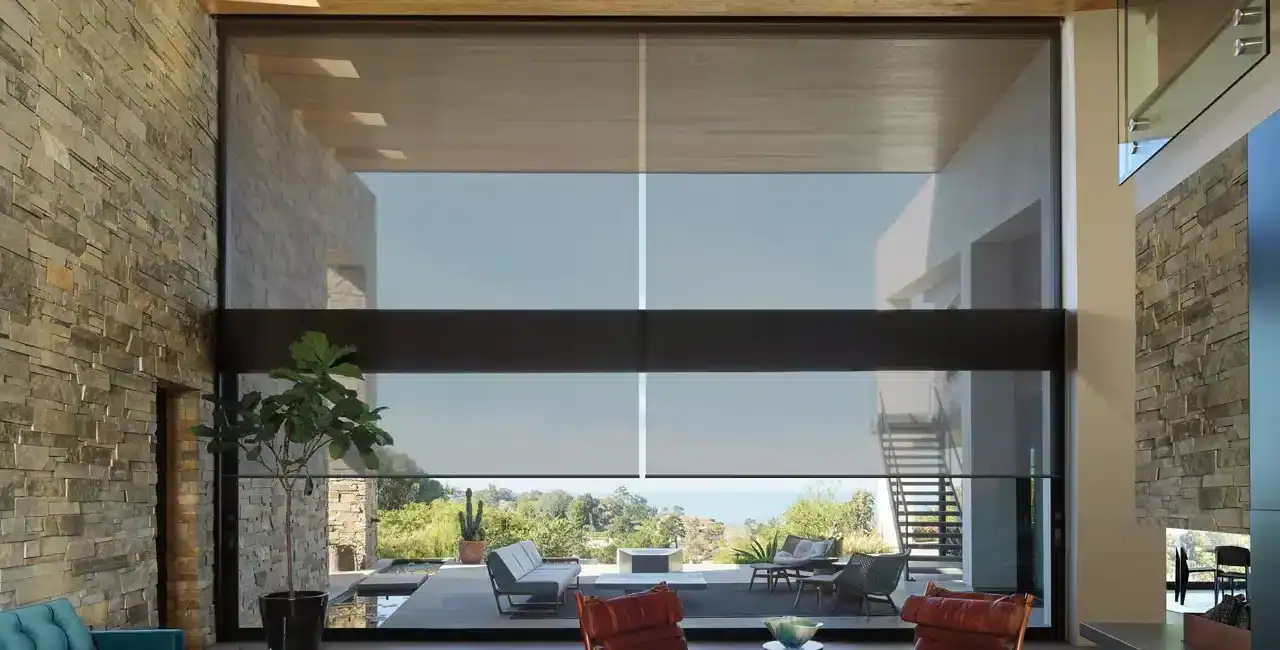 Bright, spacious modern living space featuring large glass windows, contemporary furniture, and a scenic outdoor view — perfect for relaxing and entertaining.