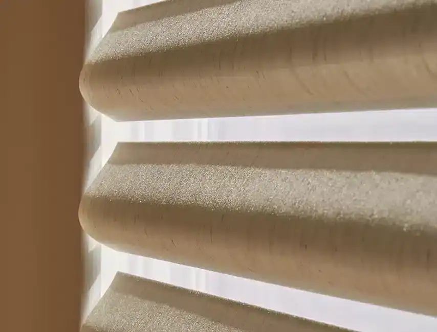 Wooden blinds with horizontal slats, natural beige color, close-up view, modern window covering, light filtering through, interior decor element, smooth texture, stylish home design, contemporary window treatment, minimalistic aesthetic.