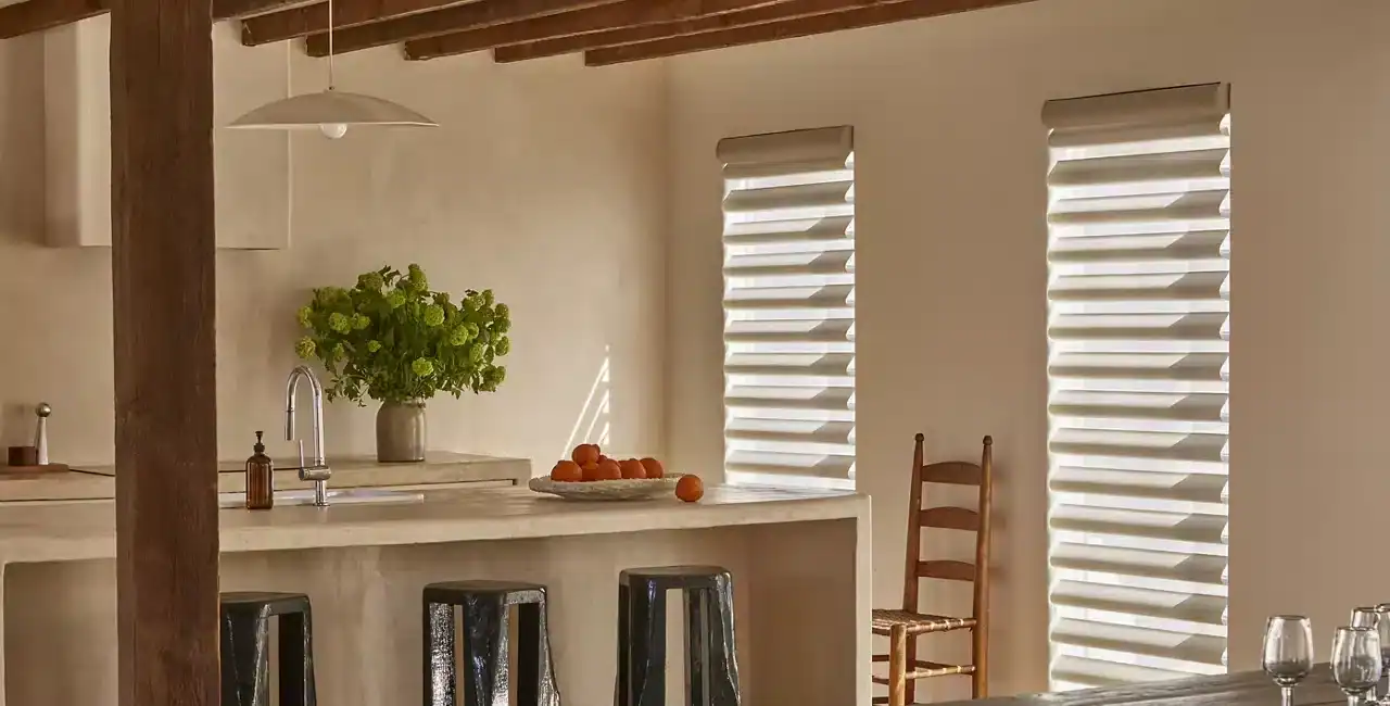 Bright and airy kitchen featuring white walls, wooden ceiling beams, and stylish window blinds. Perfect for contemporary home design.