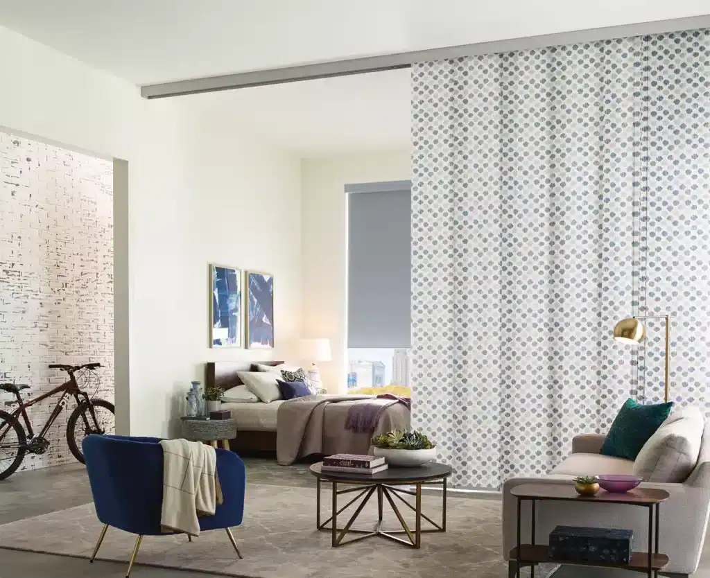Bright and stylish living room with cozy seating, contemporary decor, and a decorative partition wall for a chic home design.