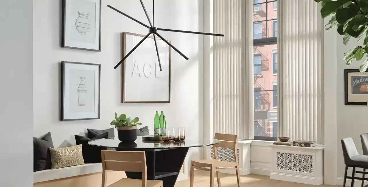 Bright and airy dining area with natural light, stylish furniture, and contemporary artwork.