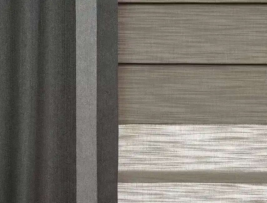 Close-up of textured window blinds and exterior siding panels in shades of beige and gray for modern home decor.
