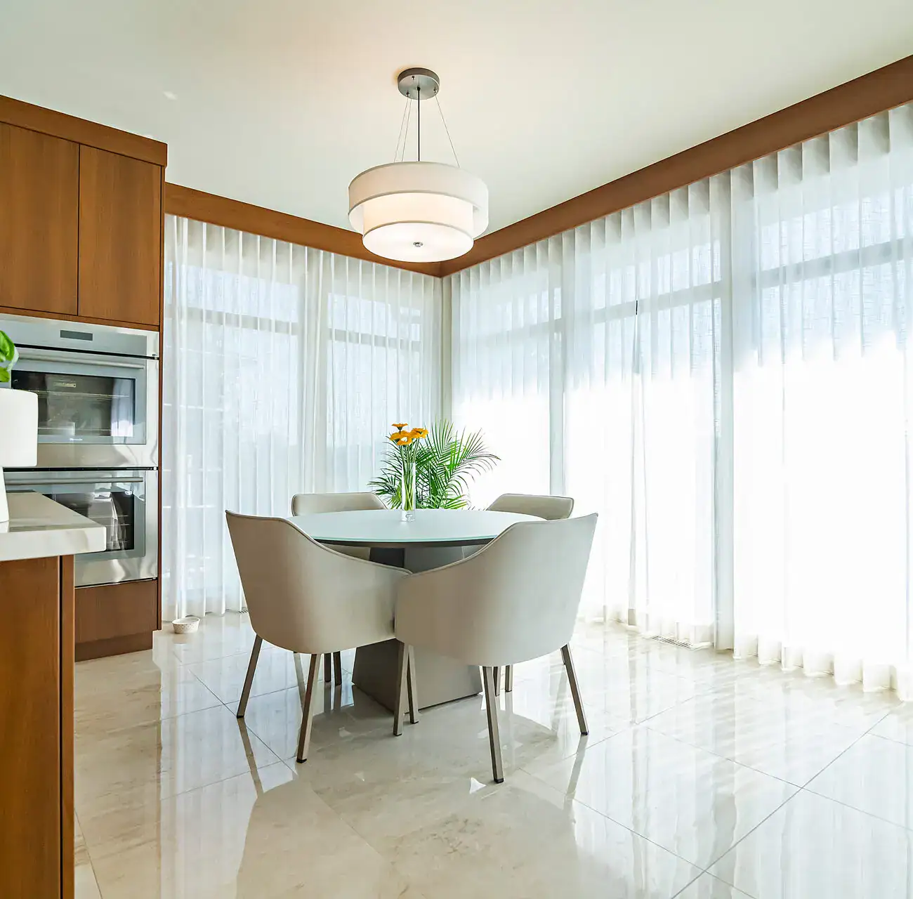 Custom drapery, modern window treatments, elegant curtains, bright dining space, natural light, stylish home decor, minimalist interior, light-filtering curtains, contemporary design, home renovation.
